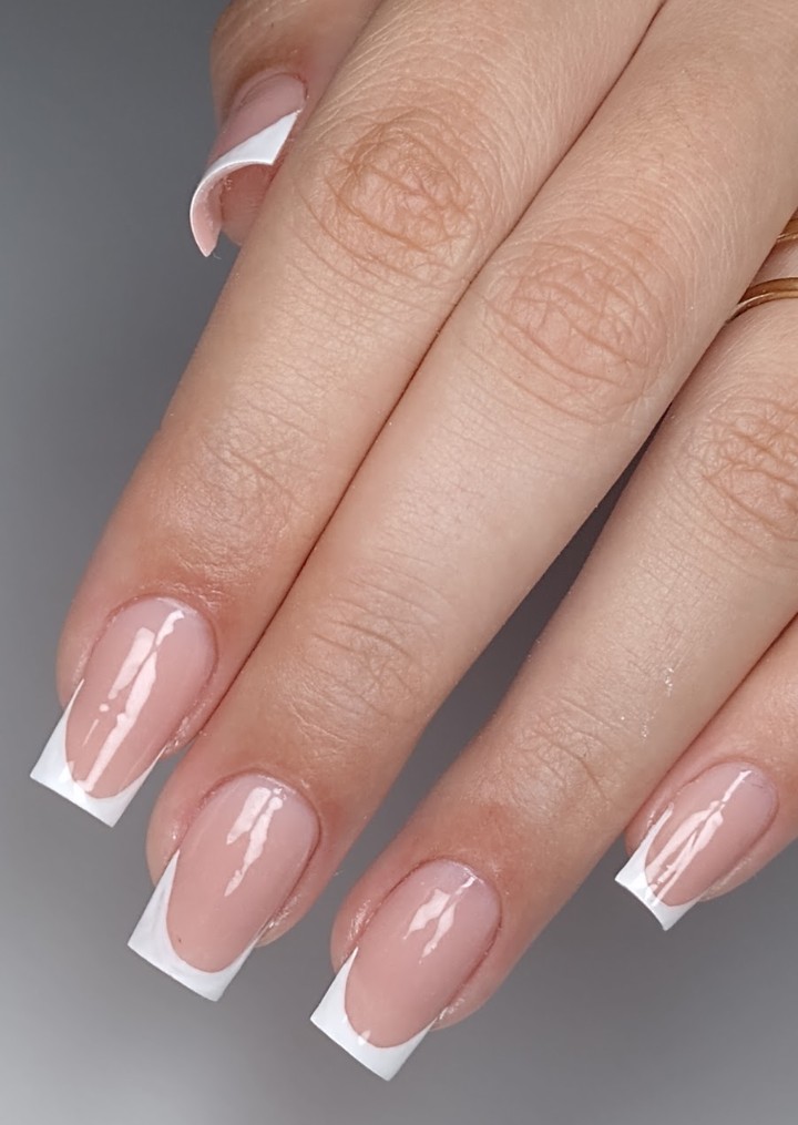 Unhas com aplicação de brilho e detalhe floral